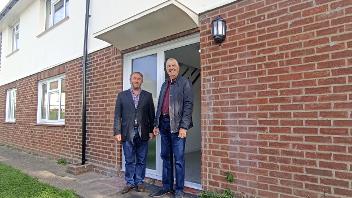 Cllr Jonathan Bianco and Cllr Eddie Lavery outside the newly-renovated property
