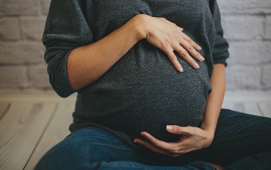 Pregnant lady with hands on bump