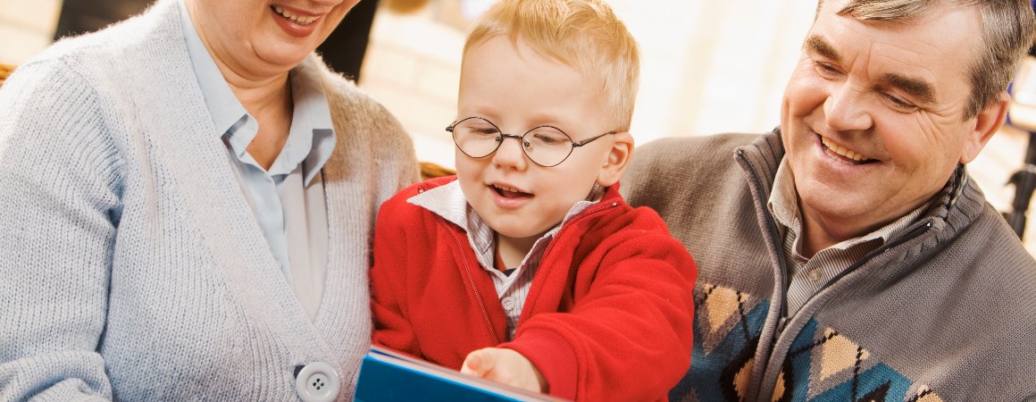 Child reading with family