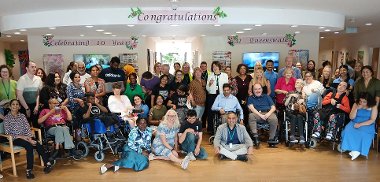 Centre users, their families, and staff past and present celebrate the 10th anniversary of the Queens Walk Resource Centre