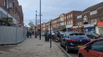 GV of Ruislip High Street showing motorbikes in pay and display bays