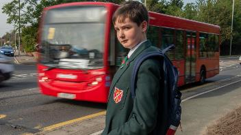 photo of Sean McDonald next to bus 