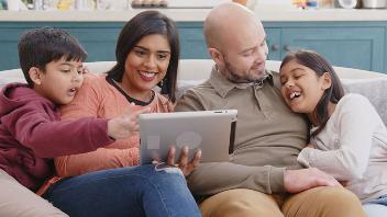 Family on sofa using a tablet